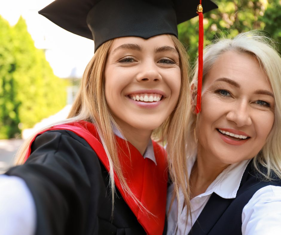graduate with mom smiles